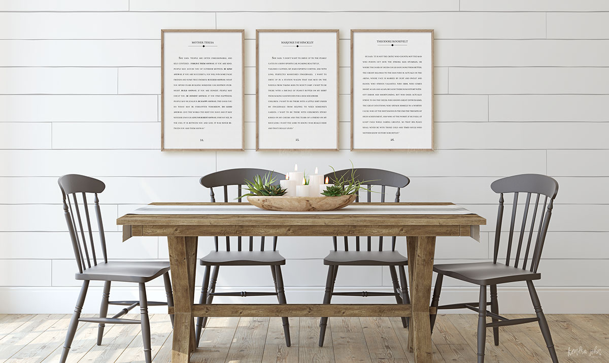 farmhouse style dinning room with large book page prints hanging on shiplap